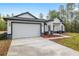 Charming single-story home with a two-car garage, stone accents, and landscaped yard at 12689 Sw 81St St, Dunnellon, FL 34432