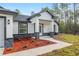 Newly built home with a front-facing two-car garage, stylish accents, and small flower bed at 12689 Sw 81St St, Dunnellon, FL 34432