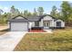 Charming single-story home with a two-car garage and fresh landscaping at 12689 Sw 81St St, Dunnellon, FL 34432