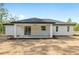 The exterior features a covered patio area, providing outdoor living space at 12689 Sw 81St St, Dunnellon, FL 34432