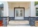 Close-up of the glass double door front entrance to a new house with gray stone accents at 12689 Sw 81St St, Dunnellon, FL 34432