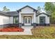 Inviting front entrance with stone pillars and a landscaped flower bed at 12689 Sw 81St St, Dunnellon, FL 34432