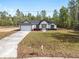 Charming exterior view of new construction home with a well manicured lawn at 12689 Sw 81St St, Dunnellon, FL 34432