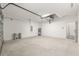Clean two car garage with newly painted white walls and concrete flooring at 12689 Sw 81St St, Dunnellon, FL 34432