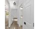 Bright hallway featuring white trim, doors, and a decorative light fixture, leading to various rooms at 12689 Sw 81St St, Dunnellon, FL 34432