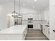 Modern kitchen with stainless steel appliances, white cabinets, and quartz countertops at 12689 Sw 81St St, Dunnellon, FL 34432
