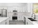 Modern kitchen showcasing stainless steel appliances, white cabinets, and quartz countertops with a view of the outdoors at 12689 Sw 81St St, Dunnellon, FL 34432