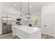 Bright kitchen with white cabinetry, stainless steel appliances, and a large center island with quartz countertops at 12689 Sw 81St St, Dunnellon, FL 34432