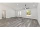 Open living room with double door entry, a ceiling fan, and gray wood flooring at 12689 Sw 81St St, Dunnellon, FL 34432