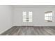 Bright living room featuring elegant double doors and modern gray wood flooring at 12689 Sw 81St St, Dunnellon, FL 34432