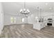 Open-concept living space featuring a modern kitchen, living room, and stylish gray wood floors at 12689 Sw 81St St, Dunnellon, FL 34432