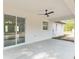 View of the covered patio with ceiling fan and sliding glass door access to the home's interior at 12689 Sw 81St St, Dunnellon, FL 34432