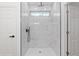 Bathroom shower featuring a rainfall shower head, glass surround, and a window at 12689 Sw 81St St, Dunnellon, FL 34432