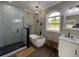 Bright bathroom featuring a soaking tub, glass shower, modern fixtures, and a large window with a scenic outdoor view at 13430 Ne 30Th Ct, Anthony, FL 32617