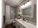 Well-lit bathroom showcasing a shower-tub, white vanity, and stylish fixtures, perfect for a relaxing and modern space at 13430 Ne 30Th Ct, Anthony, FL 32617