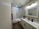 Modern bathroom with a marble shower-tub combination, white vanity, and contemporary fixtures, offering a functional design at 13430 Ne 30Th Ct, Anthony, FL 32617