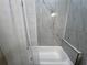 Clean bathroom features a white shower tub with marble tiled walls and a white shower curtain at 13430 Ne 30Th Ct, Anthony, FL 32617