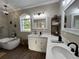 Luxurious bathroom with double sinks, marble countertops, a soaking tub, and stylish decor for a spa-like ambiance at 13430 Ne 30Th Ct, Anthony, FL 32617