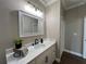 Bright bathroom featuring a white vanity with marble countertop and modern black faucet at 13430 Ne 30Th Ct, Anthony, FL 32617