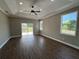 Bright bedroom with tray ceiling, recessed lighting, and sliding glass doors to the outdoor space at 13430 Ne 30Th Ct, Anthony, FL 32617