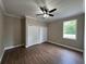 Cozy bedroom with hardwood floors, neutral walls, and a ceiling fan, creating a simple and comfortable retreat at 13430 Ne 30Th Ct, Anthony, FL 32617