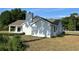 A side view of a gray house shows the stucco and chimney at 13430 Ne 30Th Ct, Anthony, FL 32617