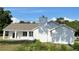 A partial side view of a gray house features stucco, chimney, and grey shingles at 13430 Ne 30Th Ct, Anthony, FL 32617