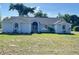 Well-maintained single-story home with a lush green lawn, showcasing its inviting curb appeal and serene setting at 13430 Ne 30Th Ct, Anthony, FL 32617