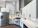Bright kitchen featuring stainless steel appliances, white cabinets, and modern backsplash at 13430 Ne 30Th Ct, Anthony, FL 32617