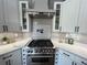 Close up of gourmet kitchen boasting stainless steel stove, custom hood, and white subway tile backsplash at 13430 Ne 30Th Ct, Anthony, FL 32617