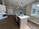 Modern kitchen island with stainless steel appliances and bright natural lighting throughout the area at 13430 Ne 30Th Ct, Anthony, FL 32617