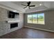 Living room featuring a modern stone fireplace, recessed lighting, and large windows for natural light at 13430 Ne 30Th Ct, Anthony, FL 32617