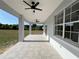 Spacious covered patio with tiled flooring, ceiling fans, and views of the backyard at 13430 Ne 30Th Ct, Anthony, FL 32617