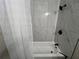 Close-up of a marble shower-tub featuring modern fixtures and a minimalist design, perfect for a luxurious bathing experience at 13430 Ne 30Th Ct, Anthony, FL 32617