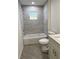 Modern bathroom with a bathtub, tiled walls, and a sleek vanity with gray shaker cabinets at 14173 Se 41St Ter, Summerfield, FL 34491