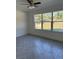 Inviting bedroom featuring large windows offering plenty of natural light and herringbone tile floors at 14173 Se 41St Ter, Summerfield, FL 34491
