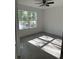 Cozy bedroom with a large window offering a scenic view of the outdoors and stylish flooring at 14173 Se 41St Ter, Summerfield, FL 34491