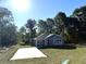 Charming single-story home with a light blue exterior, white trim, and a well-manicured front lawn at 14173 Se 41St Ter, Summerfield, FL 34491