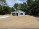 Charming single-story home with a blue exterior and white trim, nestled on a spacious lot at 14173 Se 41St Ter, Summerfield, FL 34491