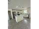 Modern kitchen showcasing white cabinets, stainless steel appliances, and a functional center island at 14173 Se 41St Ter, Summerfield, FL 34491