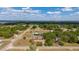 An aerial capture showing the home's position within the expansive neighborhood, set against a backdrop of trees and a lake at 14555 Se 98Th Ave, Summerfield, FL 34491