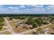 This aerial capture showcases the home's position, surrounded by an expansive neighborhood, trees, and lake views at 14555 Se 98Th Ave, Summerfield, FL 34491