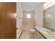 Bright bathroom features a tub with shower, and a vanity with sink at 14555 Se 98Th Ave, Summerfield, FL 34491