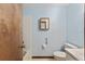 En-suite bathroom featuring blue walls, a tiled shower-tub combo, and a toilet at 14555 Se 98Th Ave, Summerfield, FL 34491
