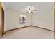The spacious bedroom features carpet floors, ceiling fan, and a window at 14555 Se 98Th Ave, Summerfield, FL 34491