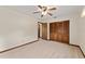 This carpeted bedroom includes a closet and ceiling fan at 14555 Se 98Th Ave, Summerfield, FL 34491