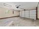 This spacious garage has an automatic door and a window at 14555 Se 98Th Ave, Summerfield, FL 34491