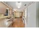 Galley kitchen featuring ample counter space, white appliances, and an open view to the living room, perfect for cooking at 14555 Se 98Th Ave, Summerfield, FL 34491