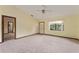 Bright living room with neutral carpet, a large window, and views of an adjacent bathroom, offering a cozy atmosphere at 14555 Se 98Th Ave, Summerfield, FL 34491