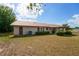 View of home from backyard with a metal roof, complemented by lush greenery at 14555 Se 98Th Ave, Summerfield, FL 34491